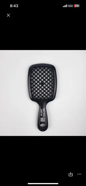 Black Paddle Hairbrush with White Bristles on White Background