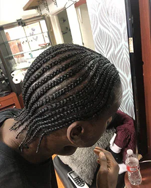 Man with Neat Cornrows in a Hair Salon